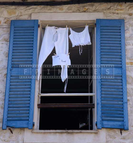 White laundry drying in the window, European cityscape