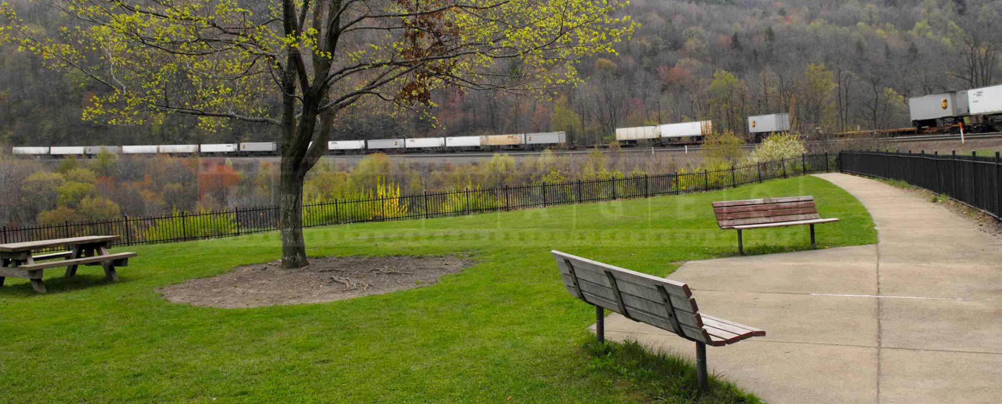 beautiful park with benches to observe trains