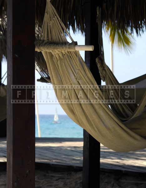 Romantic setting - relax in a beachfront hammock under the thatched roof