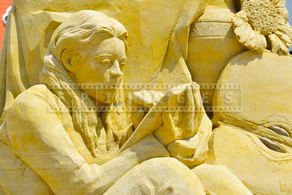 AC beach very detailed sand statue of a woman holding a tablet