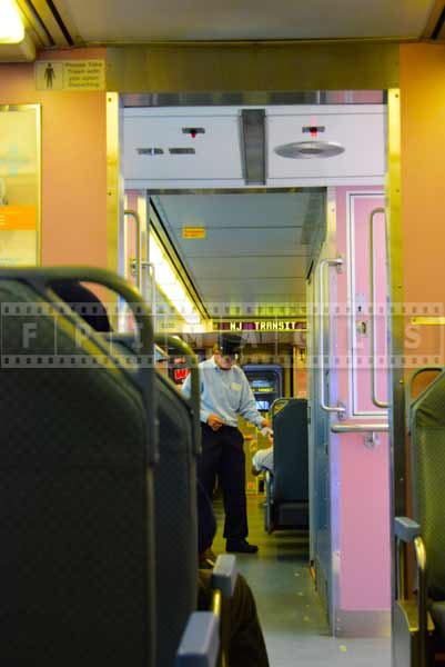 conductor checking tickets at NJ Transit train to Atlantic City