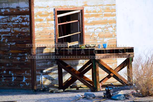 Old wooden table and house side with paint peeling off