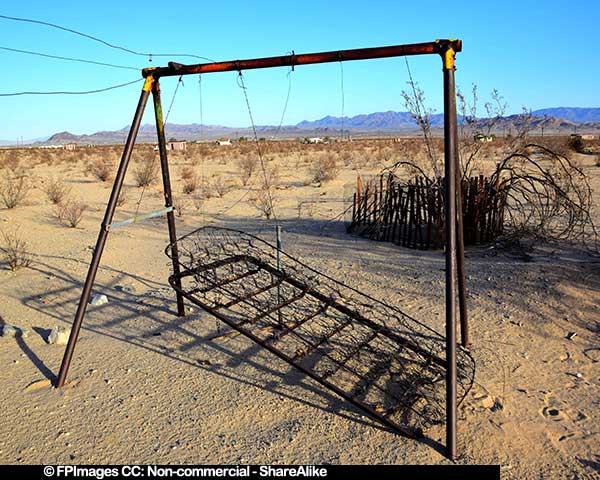 Abstract images of an borken and decaying swing in the desert