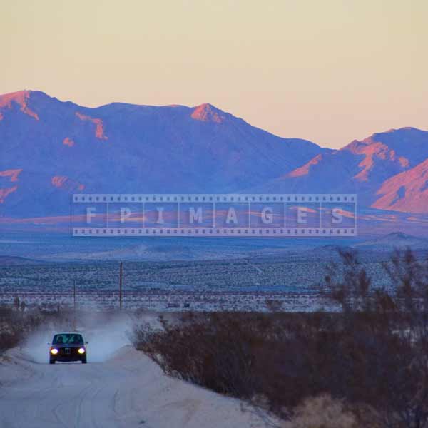 Iconic BMW 2002 on sand road at sunset, scenic car images