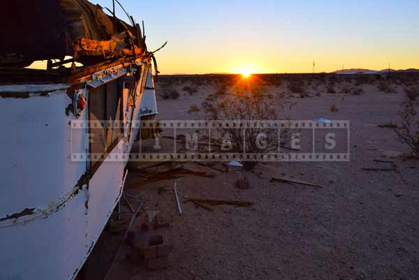 Rising sun reflecting off the old structure in the desert