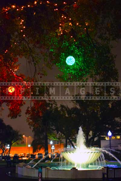 Outdoor Xmas decorations above fountain, night street photo