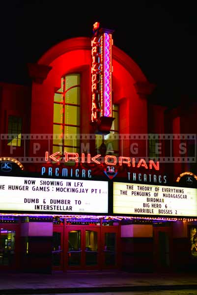 Vintage Krikorian movie theater neon sign at night