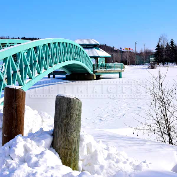 Bernard Valcourt Bridge across frozen Madawaska river in winter season