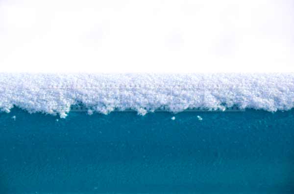 Close up view of snow on blue railings, winter abstract pictures