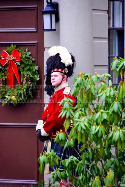 Guard in bright red highlander uniform with bearskin cap