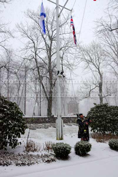 Scottish bagpiper performing in snow