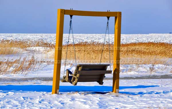 A swing by St. Lawrence river waiting for warmer times