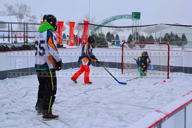 Family playing street hockey game