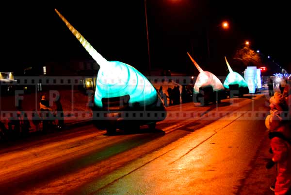 Alien mobiles glowing and colorful at night street parade