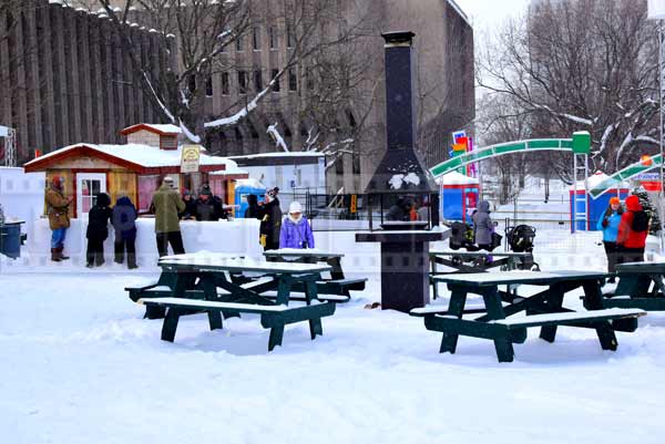 Picnic tables near maple sugar street food shack, winter pictures