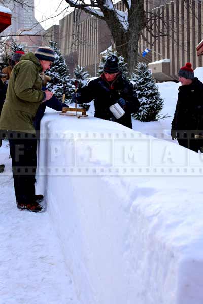 Man pouring maple syrup on fresh snow