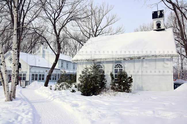 Smaller buildings near the pond, skate and snowshoe rentals