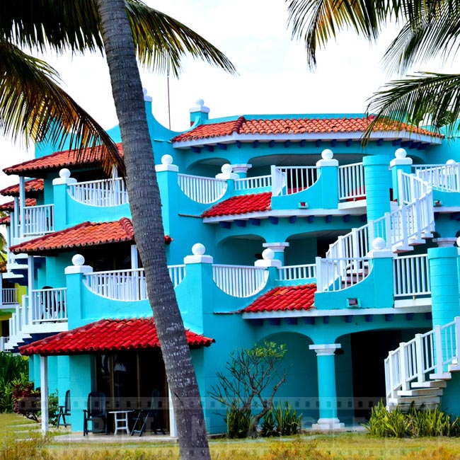 Blue hotel building and red roofs, Caribbean hotel architecture