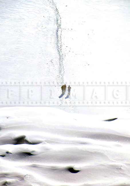 Two hikers approaching the waterfall