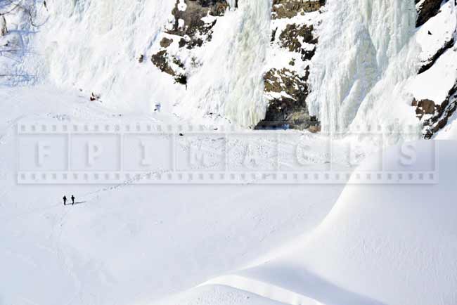 People walking hiking trail to Montmorency waterfall in winter