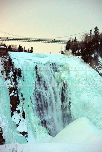 Sunset winter scenery, rushing water at Montmorency falls