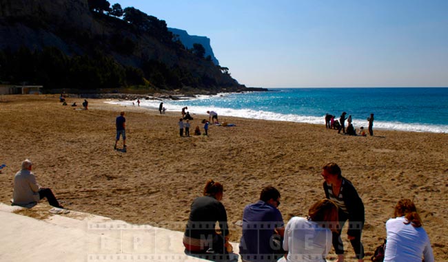 Cassis sandy beach, people enjoy the spring sun