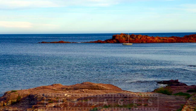 Seascape with single yacht in the cove