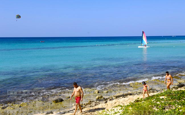 Family walking along the beautiful ocean