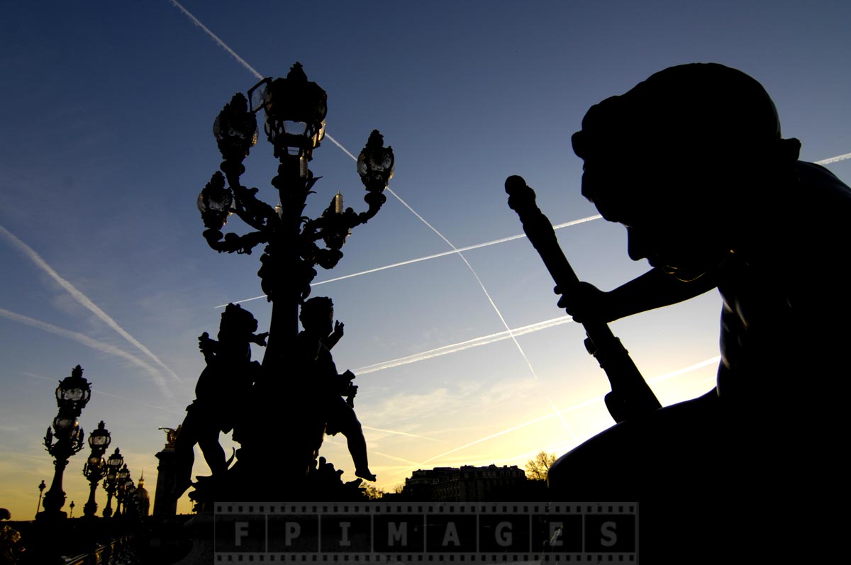 Awesome silhouettes of Alexander III bridge statues at sunset