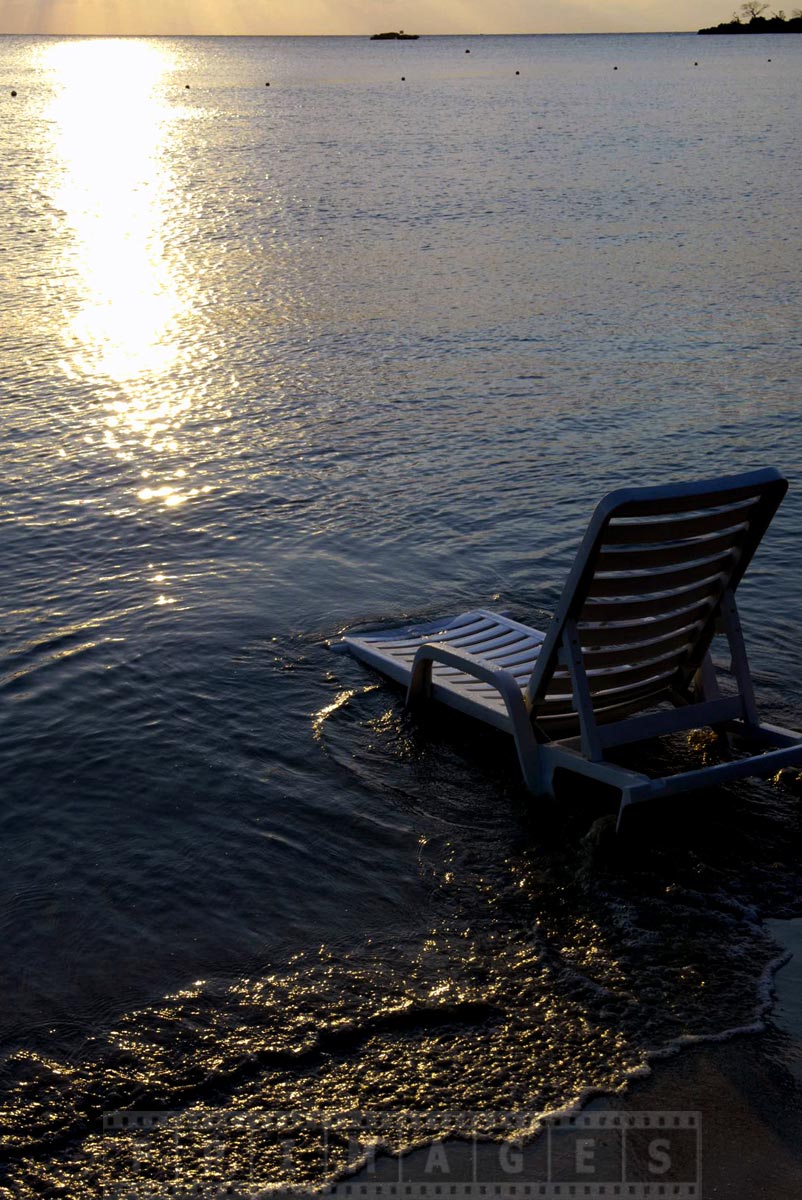 Enjoy romantic sunset in beach chaise lounge by the sea