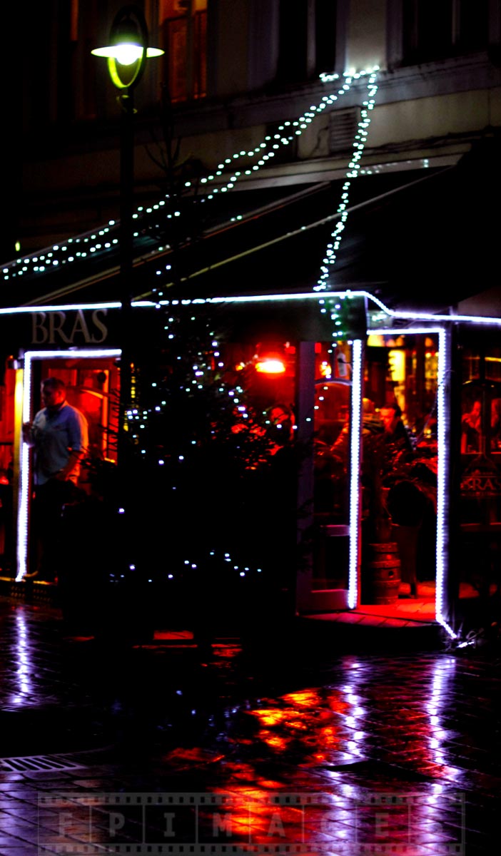 Restaurant with lights decorations at night in Bruges