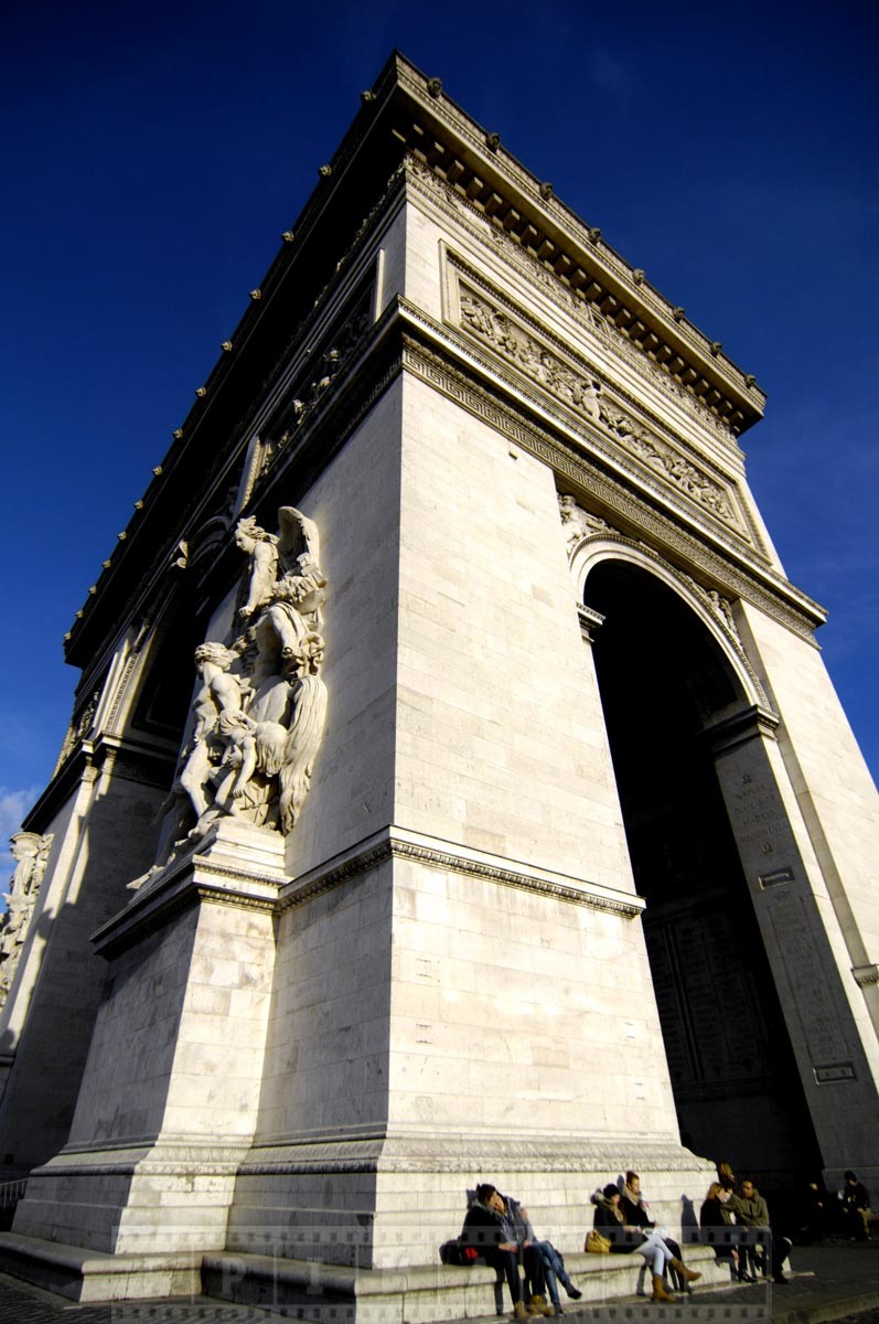 Couples enjoy sunshine at Arc de Triomphe