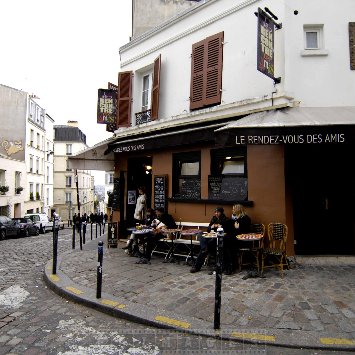 Couple enjoy coffee at a cute small restaurant in Montmarte