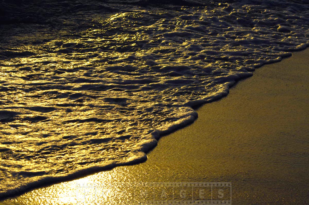 Romantic walk along the unspoiled beach at sunset