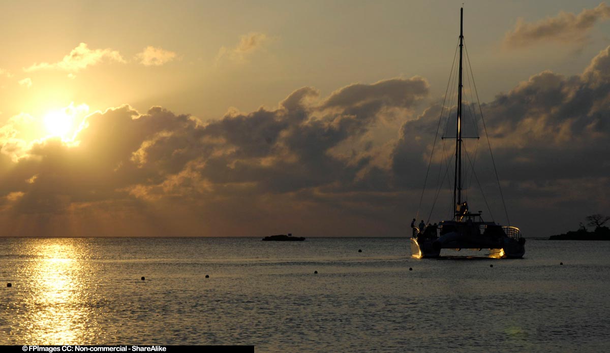 Romantic catamaran cruise during amazing tropical sunset on Bloody Bay