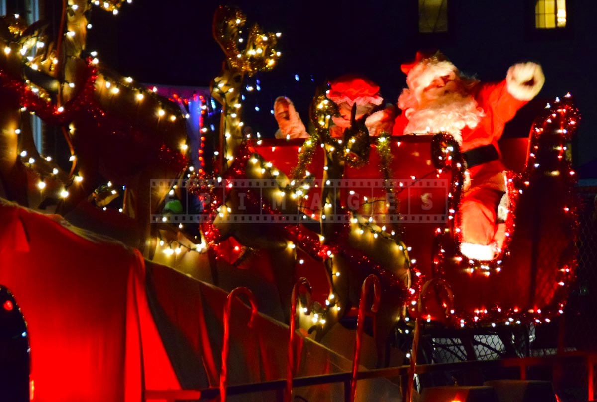 Santa greeting people during Christmas parade