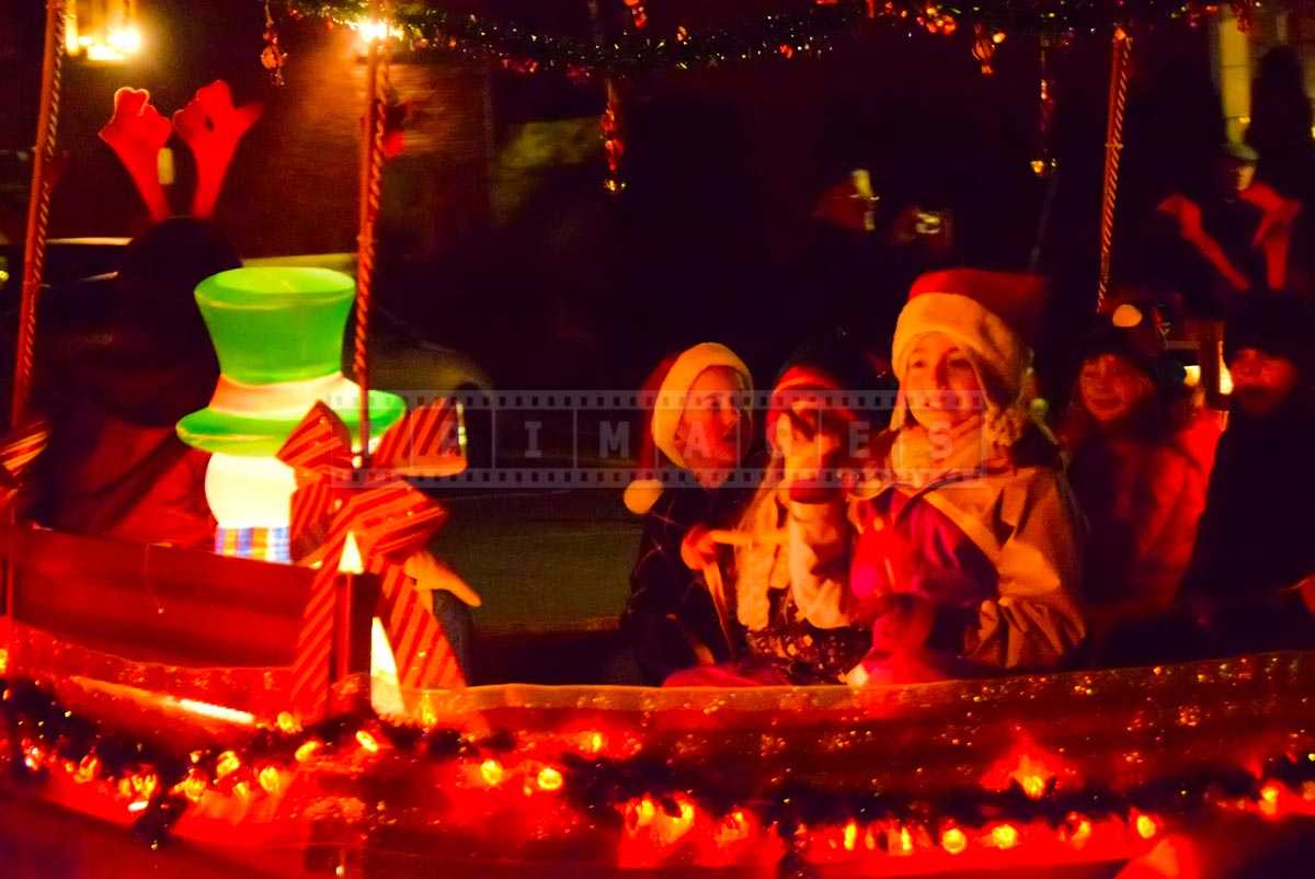 Kids riding bright red float