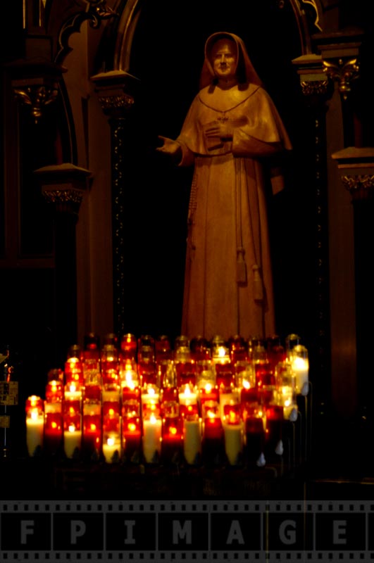 Statue of a saint with candles