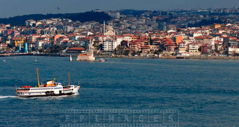 Istanbul ferry and Maiden Tower in Bosphorus