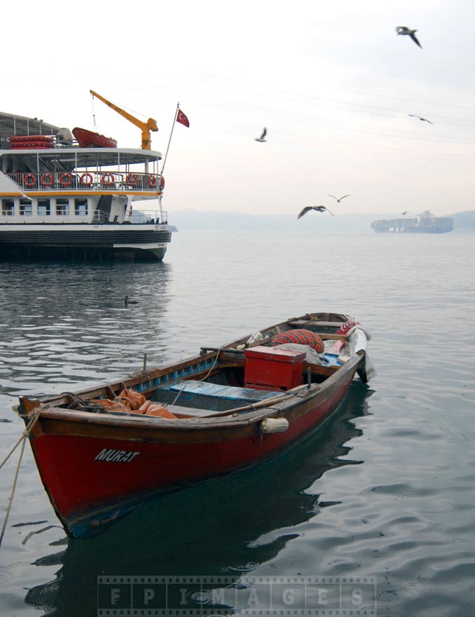 Fishing boat, ferry and a container-ship at Bosporus