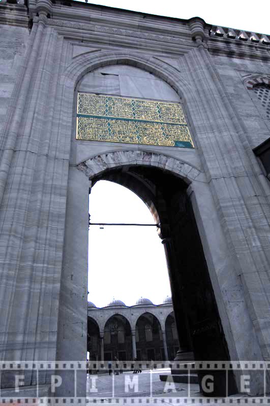 Golden calligraphy writing above the entrance - exterior decor of the mosque