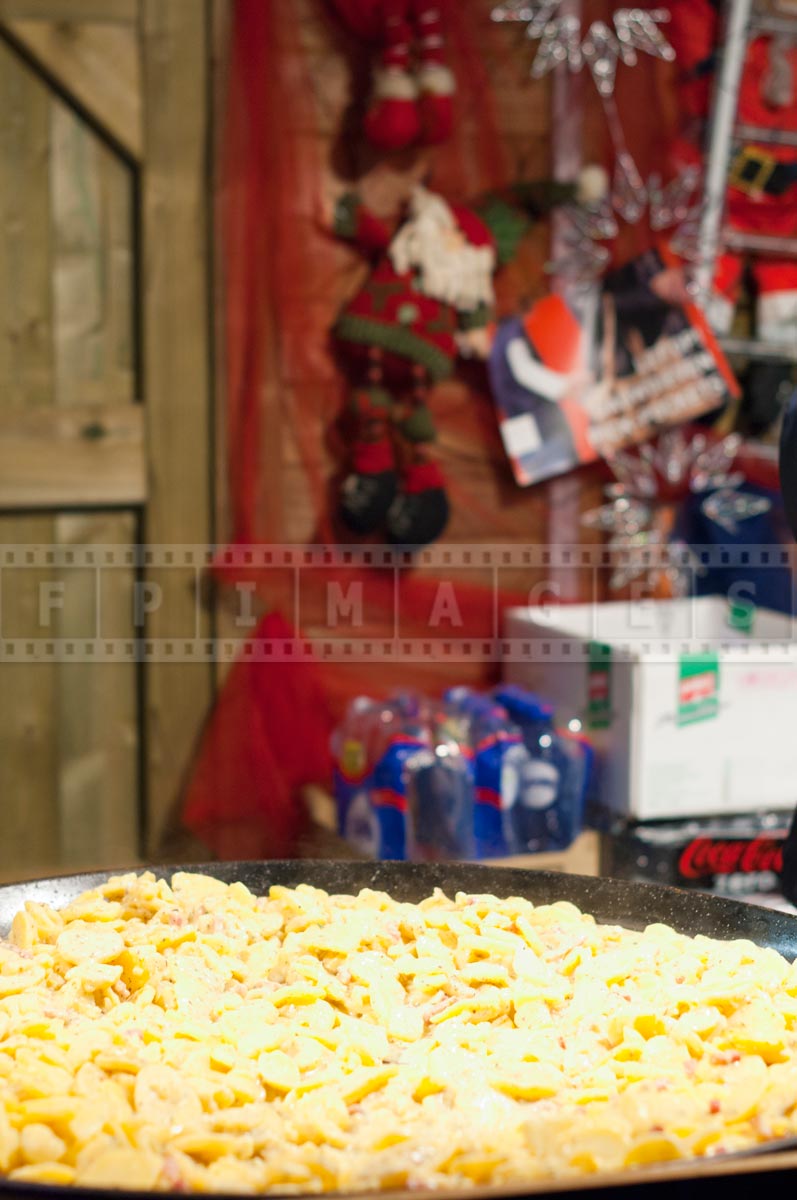 a pan of tartiflette with Christmas decoarions in the background