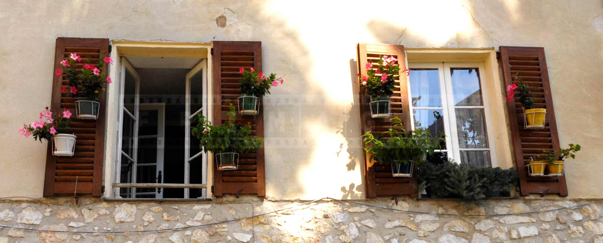 flowers and window shutters in small French town