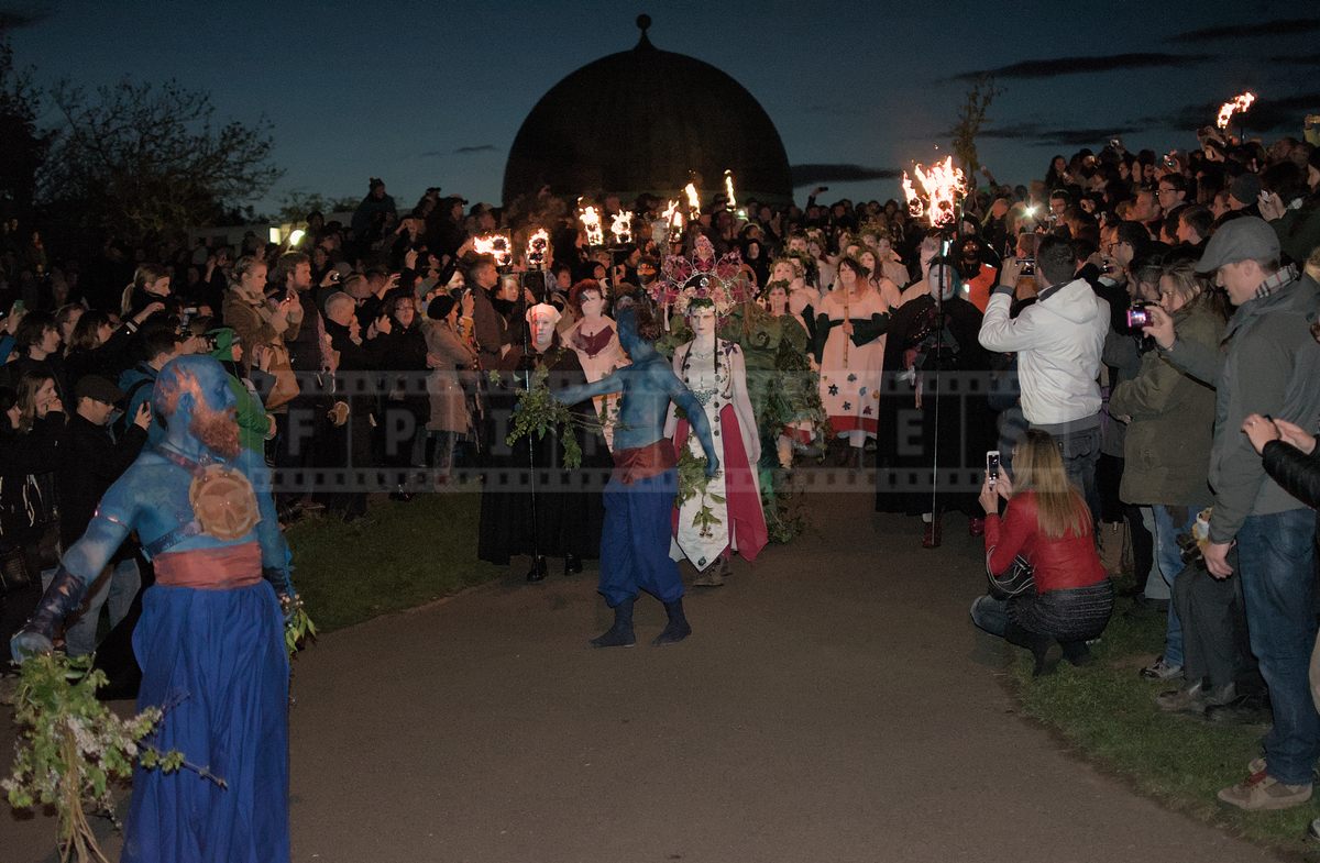 Spectators watching and taking pictures of the May Queen march at Beltane Fire Festival